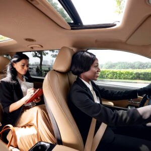 woman-driving-her-taxi-cab-with-her-client-backseat